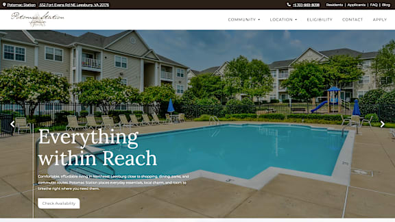 A pool surrounded by apartment buildings with a sign that says "Everything within Reach.".