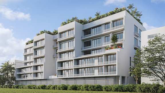 A modern building with balconies and plants on the roof.