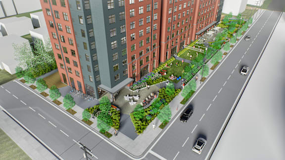 A street view of a city with cars and buildings. at University Commons in Pittsburgh, PA