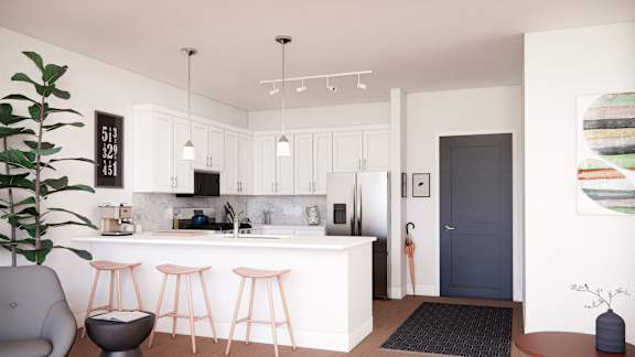 A modern kitchen with a bar stool and a potted plant.