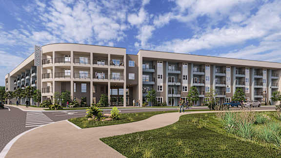 A modern apartment building with a walkway in front.