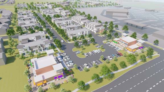 an aerial view of a city street with buildings and cars