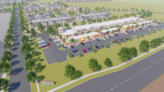 an aerial view of a parking lot with buildings and cars