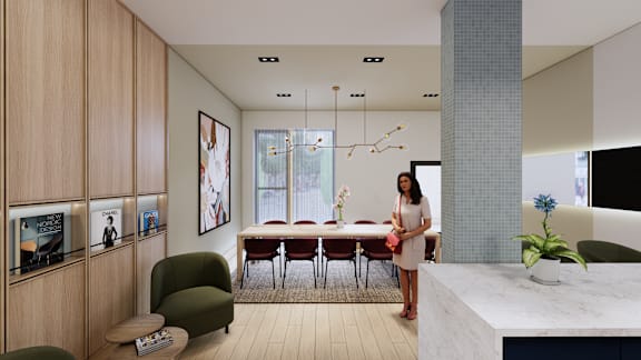 A woman stands in a modern room with a dining table and chairs.