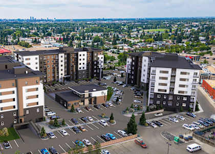 A parking lot is in front of a building with a large parking area.