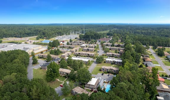 A bird's eye view of a residential area with houses and a swimming pool.
