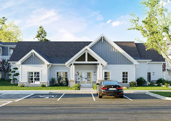 A white house with a black car parked in front.at The Landings at Hard Scrabble, South Carolina, 29203