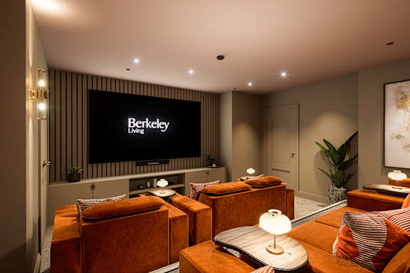 A living room with a glass table and chairs, a potted plant, and pictures on the wall.