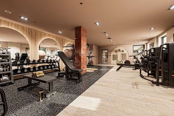 A gym with a row of stationary bikes and a neon sign that says "Eat Sleep Sweat Repeat".