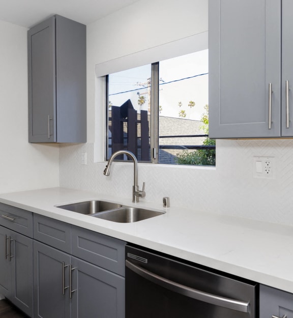 an empty kitchen with a sink and a window
