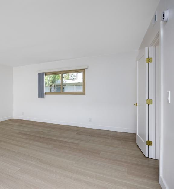 a bedroom with a bed and a dresser and a window