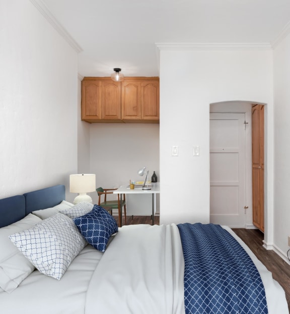 a bedroom with a bed and a tv