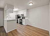 Thumbnail 7 of 19 - A kitchen with white cabinets and black appliances. at Highland Park, Texas, 76132