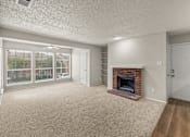 Thumbnail 8 of 19 - A living room with a fireplace and sliding glass doors. at Highland Park, Texas, 76132