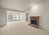 Thumbnail 13 of 19 - A living room with a fireplace and a carpeted floor. at Highland Park, Texas, 76132
