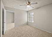 Thumbnail 16 of 19 - A room with a ceiling fan and carpeted floor. at Highland Park, Texas, 76132