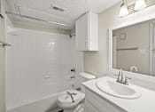 Thumbnail 19 of 19 - A white bathroom with a toilet, sink, and bathtub. at Highland Park, Texas, 76132