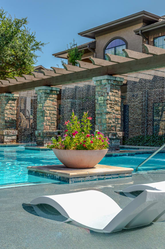 a swimming pool with a house in the background