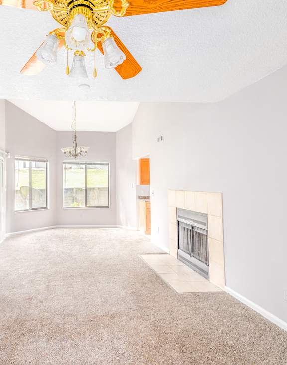 A living room with a fireplace and a chandelier.