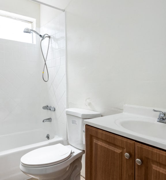 an empty bathroom with a sink toilet and shower