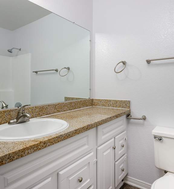 A white toilet sits next to a sink in a bathroom.