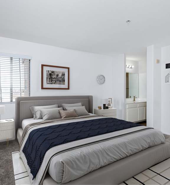 A bedroom with a large bed and a clothing rack.