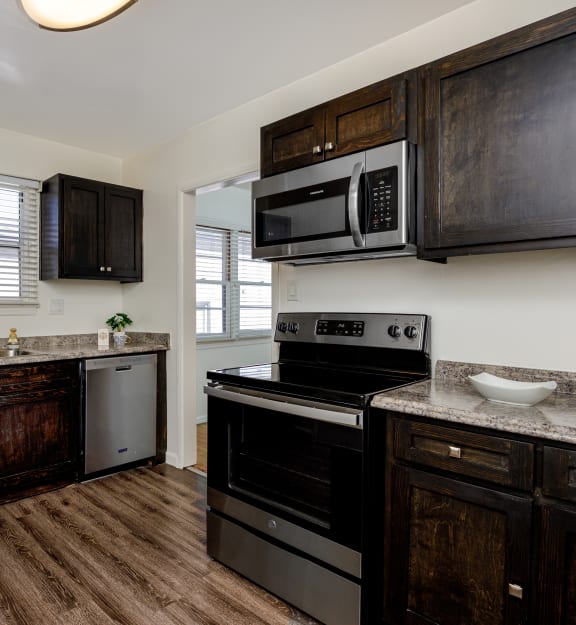 a kitchen with stainless steel appliances and wooden cabinets