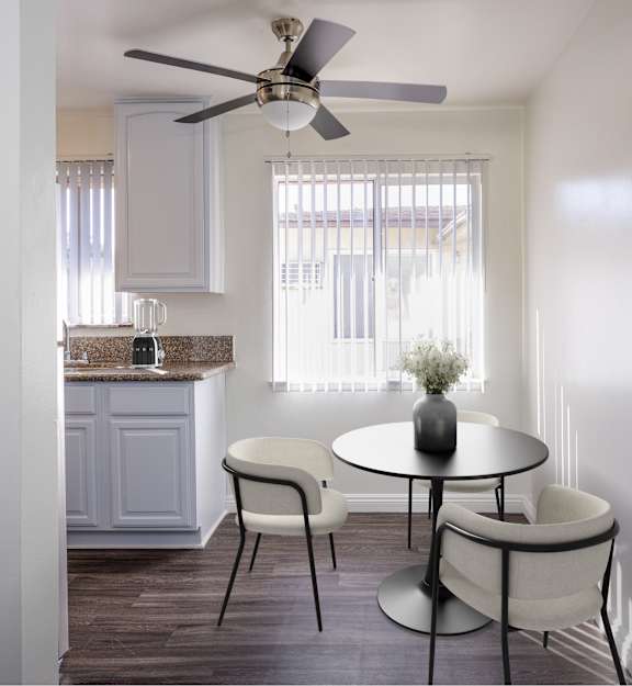 a kitchen and dining area with a table and chairs and a ceiling fan