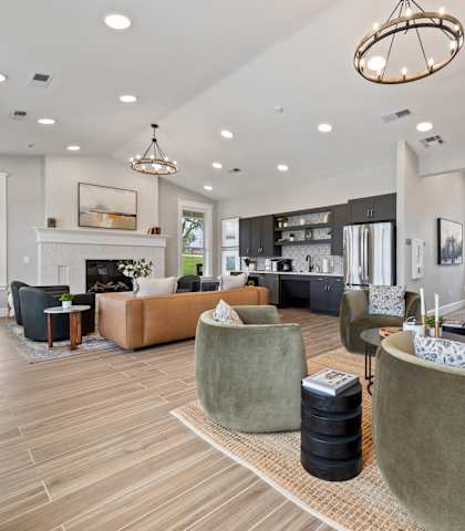 a living room with couches and chairs and a fireplace at Sandy Creek Apartments, Texas, 77807