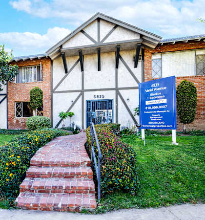 a building with a blue sign in front of it