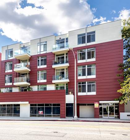 a red apartment building on the corner of a street