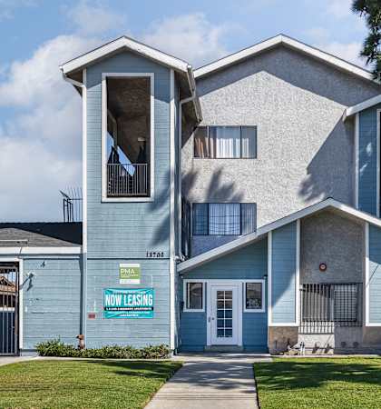 A blue house with a sign that says "Now Leasing".