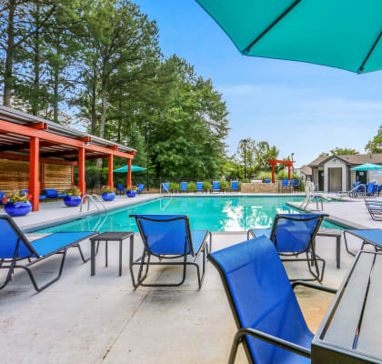 our apartments have a resort style pool with chairs and tables