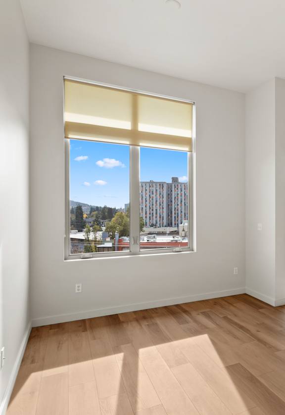 A room with a window overlooking a cityscape.