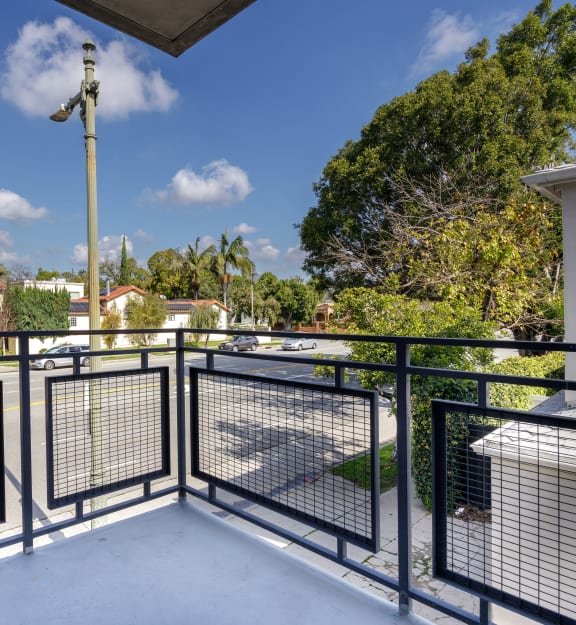 a patio with a table and two chairs on a balcony
