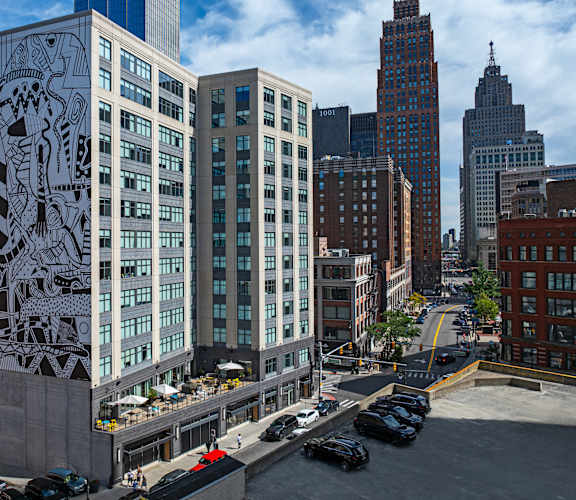 A large mural of a lion is on the side of a building at 28Grand, Detroit, MI