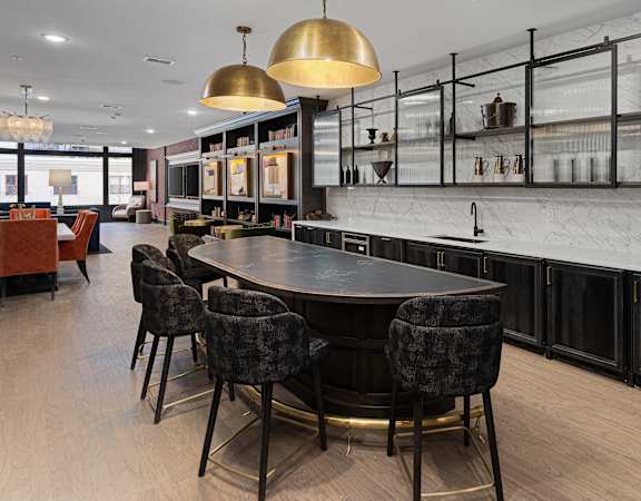a kitchen with a large table and chairs in a restaurant at The Madison, Columbus, OH, 43215
