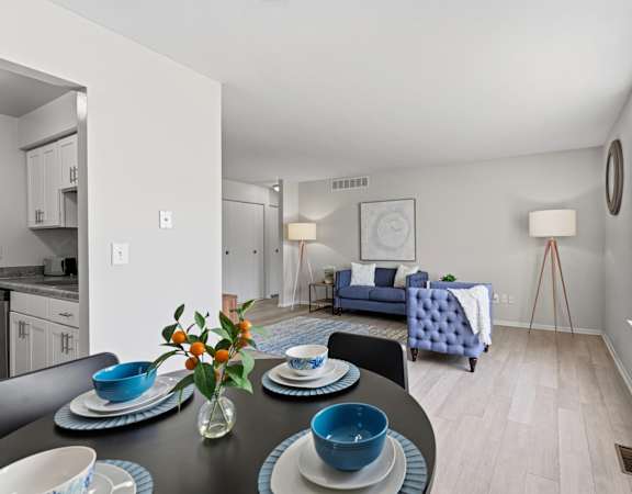 A dining table with blue plates and bowls is set for a meal.