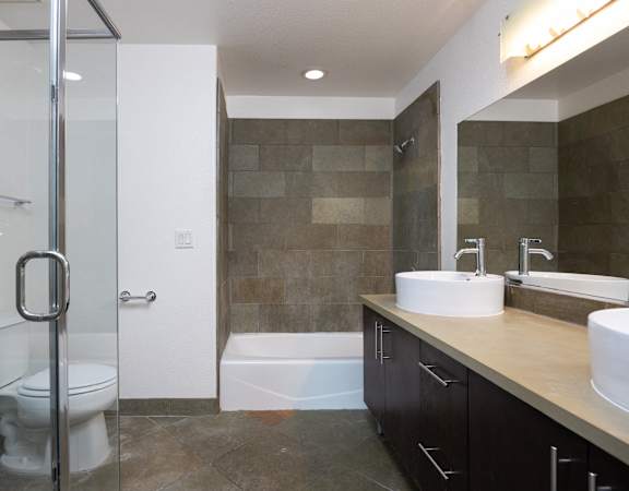 a bathroom with a toilet and a shower and a sink