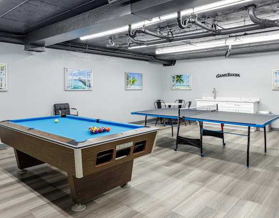 two pool tables and two ping pong tables in a room with other tables
