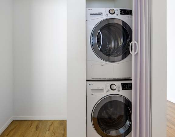 a front loading washer and dryer in a laundry room