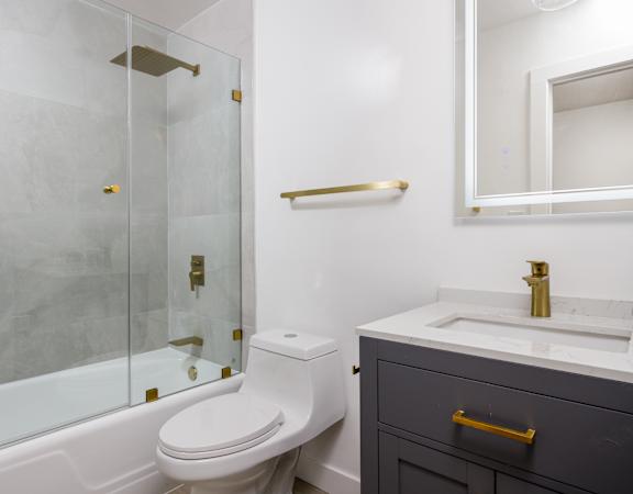 a bathroom with a toilet and a shower and a sink