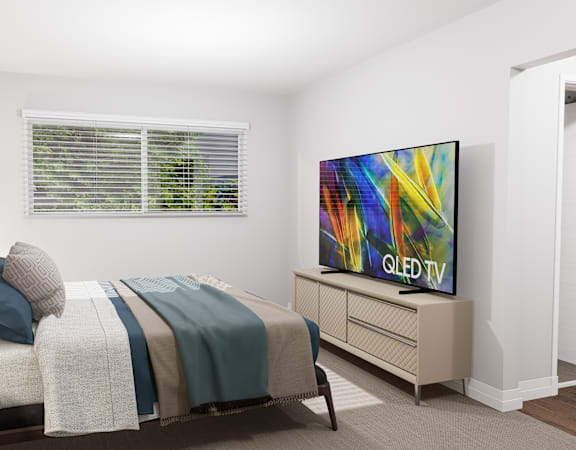 a bedroom with a bed and a tv in it