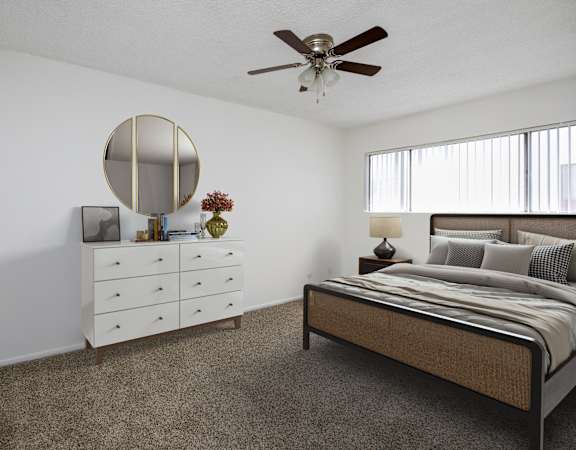 a bedroom with a bed and a white dresser and a ceiling fan