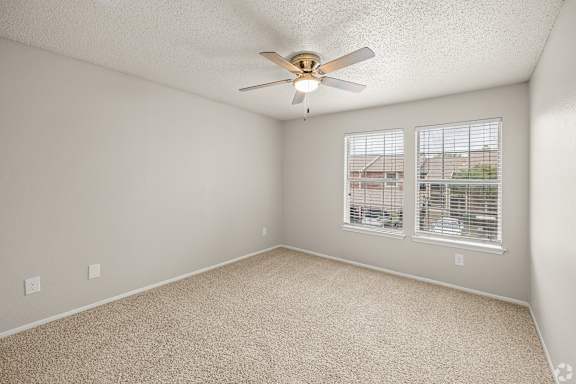 A room with a ceiling fan and carpeted floor. at Highland Park, Texas, 76132