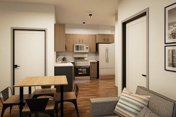 A modern kitchen with a dining table and chairs.