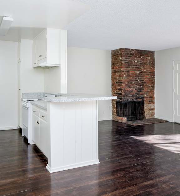 a room with four washers and dryers and a row of refrigerators