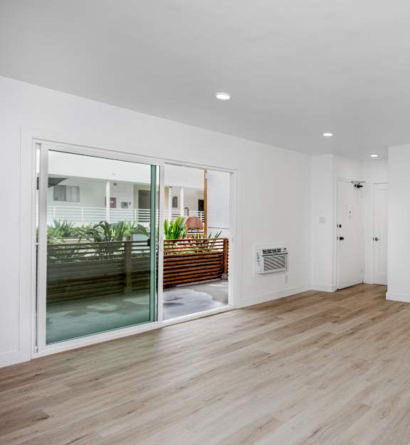 an empty room with white walls and wooden floors