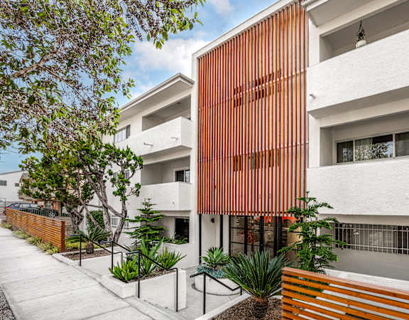 A modern building with a white and orange facade.