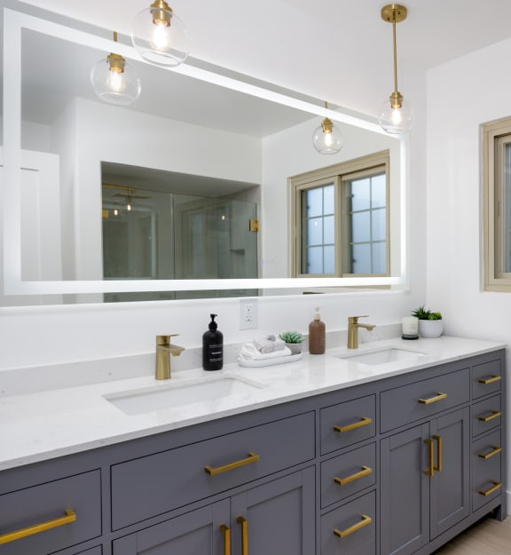 a laundry room with white appliances and white cabinets